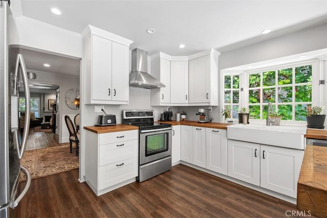 19172 Sierra Maria Rd, Irvine, CA 92603 - kitchen featuring appliances with stainless steel finishes, wooden counters, wall chimney range hood, a sink, and dark wood-style floors