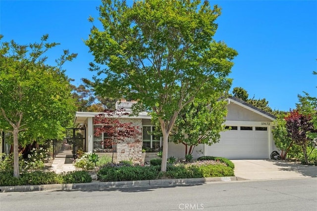 19172 Sierra Maria Rd, Irvine, CA 92603 - obstructed view of property featuring an attached garage and concrete driveway