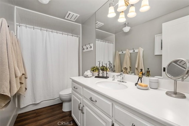 19172 Sierra Maria Rd, Irvine, CA 92603 - bathroom with vanity, toilet, wood finished floors, and a chandelier