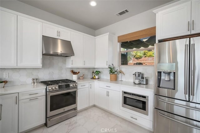 997 Canyon Ln, Pismo Beach, CA 93449 - kitchen with appliances with stainless steel finishes, under cabinet range hood, light countertops, decorative backsplash, and recessed lighting