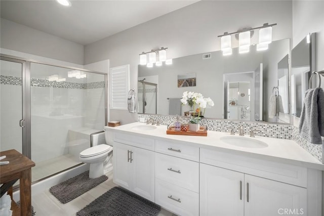 997 Canyon Ln, Pismo Beach, CA 93449 - full bathroom featuring double vanity, a shower stall, decorative backsplash, and toilet