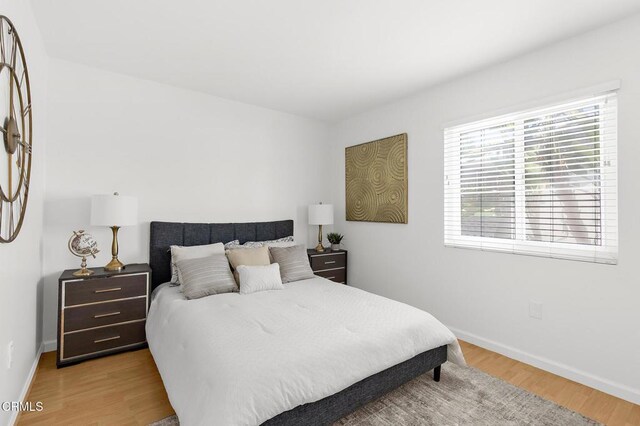 10801 Blix St Unit 2, Toluca Lake, CA 91602 - bedroom with multiple windows and wood finished floors