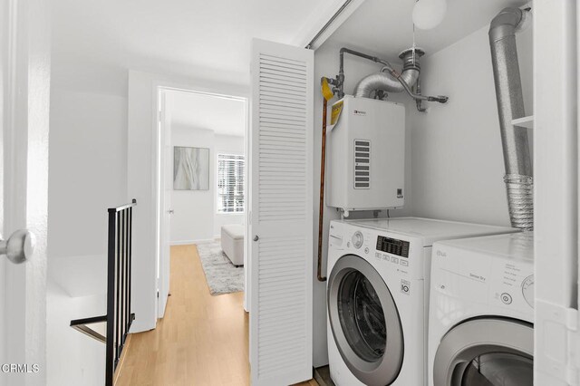 10801 Blix St Unit 2, Toluca Lake, CA 91602 - laundry room with tankless water heater, washer and clothes dryer, and light wood-style floors