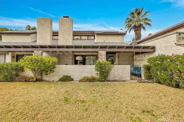 26 Pueblo Vista Dr, Palm Springs, CA 92264 - rear view of property with a tile roof, a chimney, and stucco siding