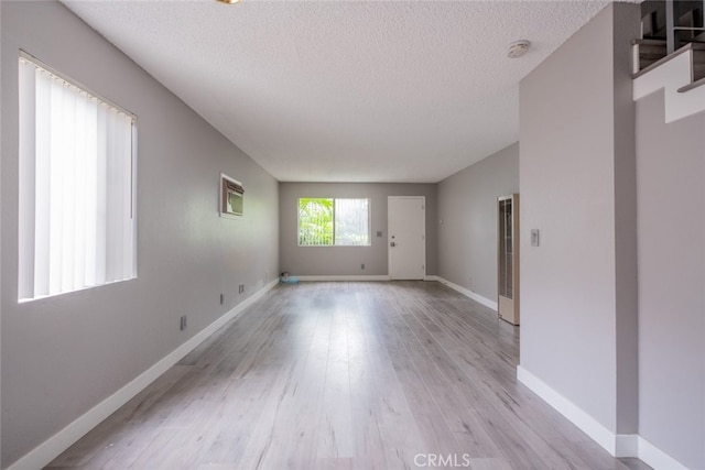 1341 N Keystone St, Burbank, CA 91506 - spare room with a heating unit, light wood finished floors, and a textured ceiling