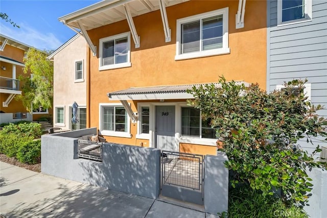 949 Humbert Ave, San Luis Obispo, CA 93401 - townhome / multi-family property with a gate, a fenced front yard, and stucco siding