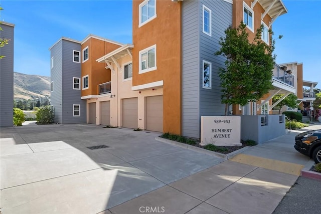 949 Humbert Ave, San Luis Obispo, CA 93401 - view of building exterior with a garage, driveway, and a mountain view