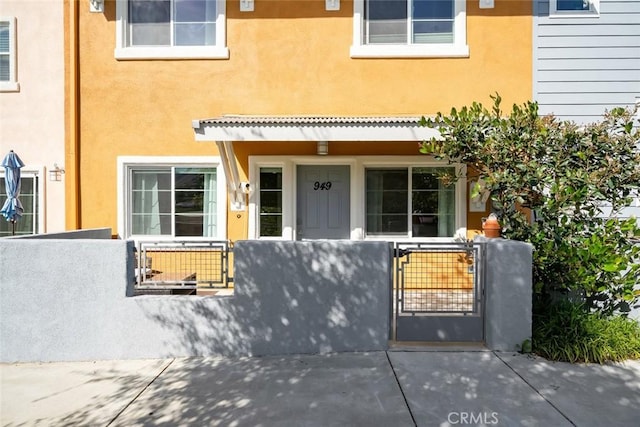 949 Humbert Ave, San Luis Obispo, CA 93401 - view of front of house with a fenced front yard, stucco siding, and a gate
