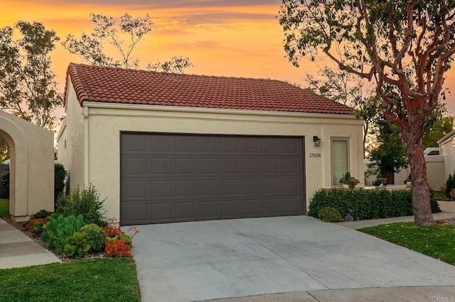 17636 Plaza Arica, San Diego, CA 92128 - mediterranean / spanish house featuring stucco siding, concrete driveway, a tile roof, and an attached garage