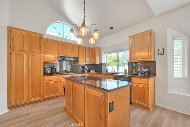 10707 Champagne Rd, Alta Loma, CA 91737 - kitchen featuring under cabinet range hood, light wood-style flooring, a chandelier, decorative backsplash, and high vaulted ceiling