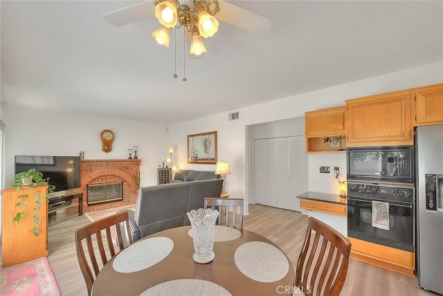 10707 Champagne Rd, Alta Loma, CA 91737 - dining area with light wood finished floors, a fireplace, and ceiling fan