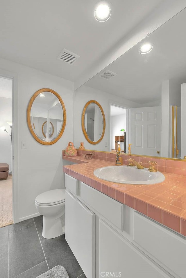 10707 Champagne Rd, Alta Loma, CA 91737 - bathroom with vanity, tile patterned flooring, toilet, and recessed lighting