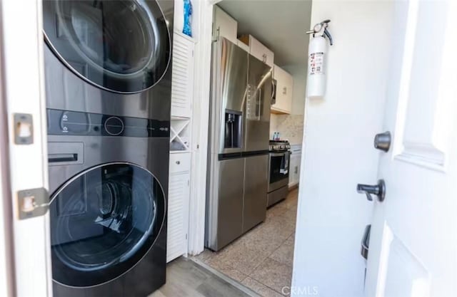 1390 Gundry Ave, Long Beach, CA 90813 - washroom featuring stacked washer / drying machine and light tile patterned floors