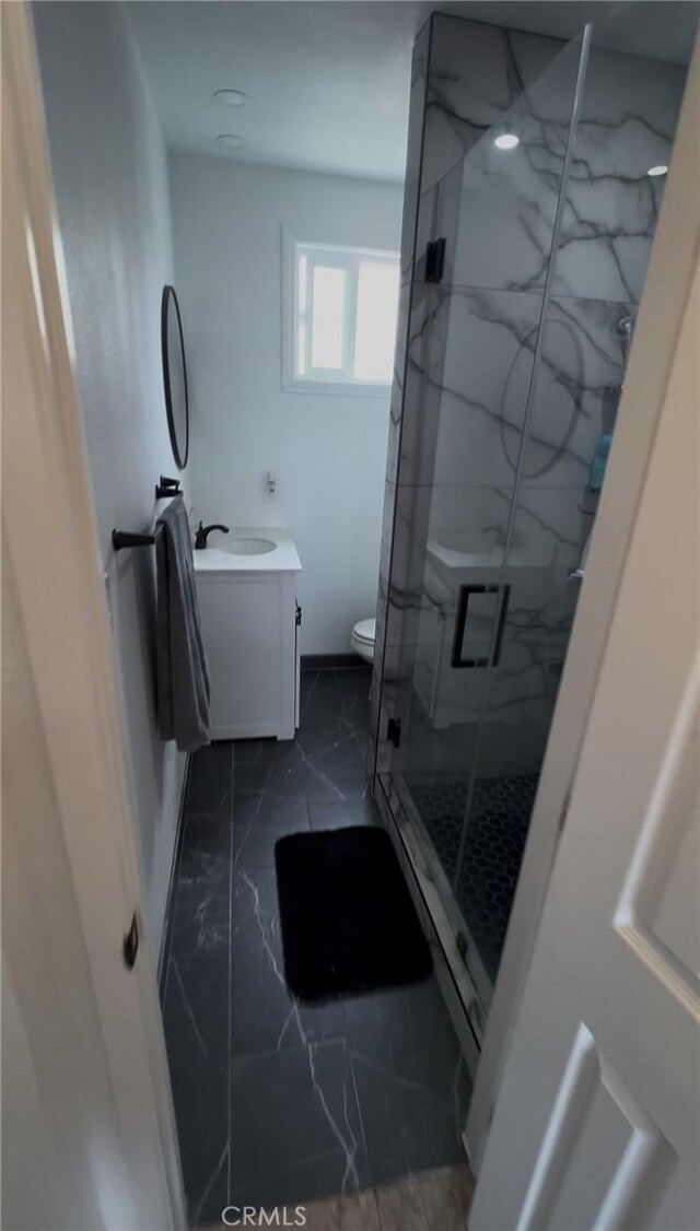1390 Gundry Ave, Long Beach, CA 90813 - bathroom featuring marble finish floors, vanity, a marble finish shower, baseboards, and toilet