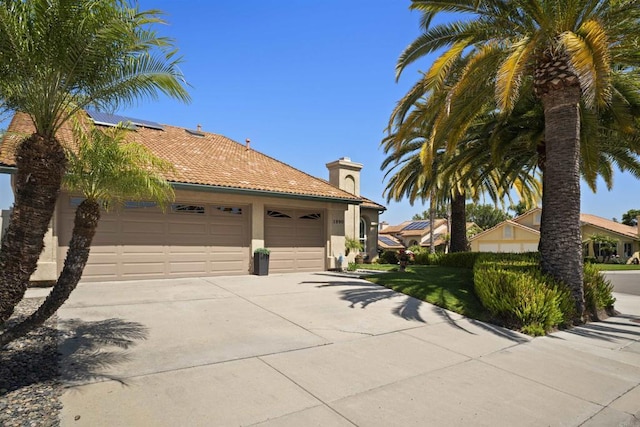 1990 Willowbrook Dr, Oceanside, CA 92056 - view of front of home featuring concrete driveway, a chimney, a garage, stucco siding, and a tile roof