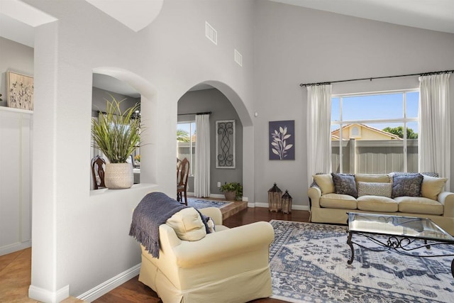1990 Willowbrook Dr, Oceanside, CA 92056 - living area featuring a towering ceiling, arched walkways, and baseboards