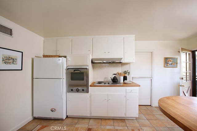 2057 Oakwood St, Pasadena, CA 91104 - kitchen with freestanding refrigerator, under cabinet range hood, wall oven, tasteful backsplash, and light tile patterned floors