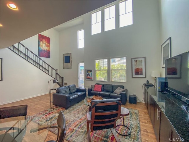 5 Abarrota St, Rancho Mission Viejo, CA 92694 - living area with a towering ceiling and light wood-style flooring