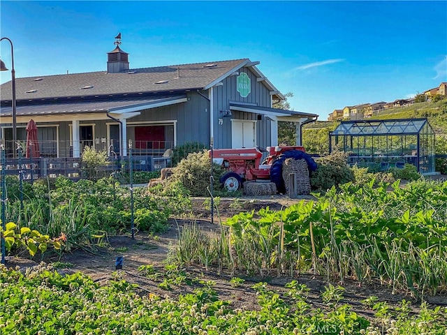 5 Abarrota St, Rancho Mission Viejo, CA 92694 - back of house featuring a greenhouse, board and batten siding, roof with shingles, and an outbuilding