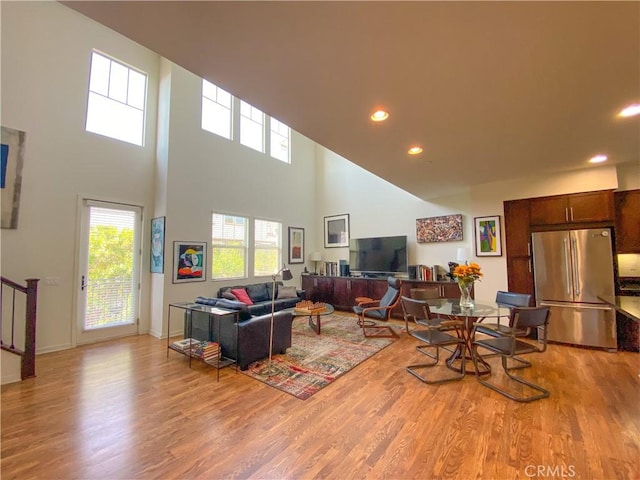 5 Abarrota St, Rancho Mission Viejo, CA 92694 - living area featuring a towering ceiling, light wood-type flooring, plenty of natural light, recessed lighting, and baseboards