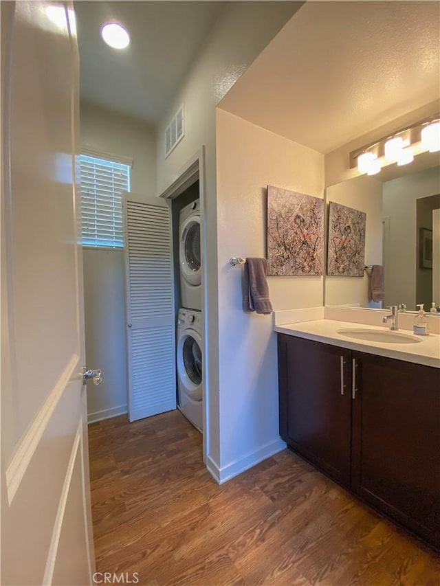 5 Abarrota St, Rancho Mission Viejo, CA 92694 - laundry room with stacked washer / drying machine, dark wood finished floors, and baseboards