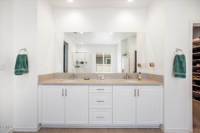 30106 Stargazer Way, Menifee, CA 92584 - bathroom with double vanity, a stall shower, a walk in closet, and recessed lighting
