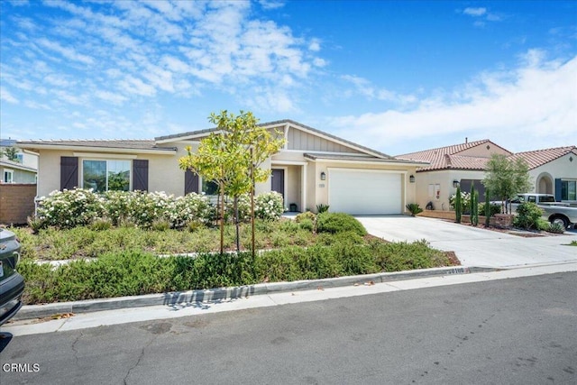 30106 Stargazer Way, Menifee, CA 92584 - view of front of property with an attached garage, concrete driveway, stucco siding, and a tiled roof