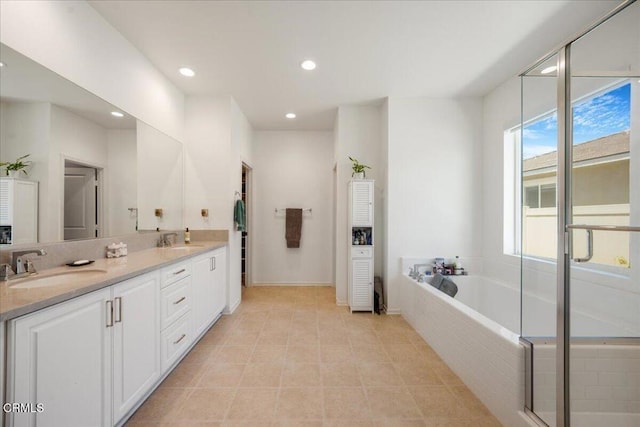 30106 Stargazer Way, Menifee, CA 92584 - bathroom featuring double vanity, a garden tub, recessed lighting, tile patterned floors, and baseboards