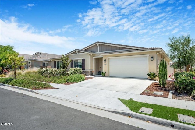 30106 Stargazer Way, Menifee, CA 92584 - view of front of house featuring an attached garage, driveway, stucco siding, and stone siding