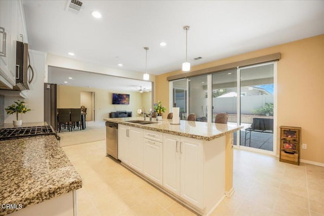 30106 Stargazer Way, Menifee, CA 92584 - kitchen featuring stainless steel appliances, open floor plan, light stone counters, white cabinets, and pendant lighting