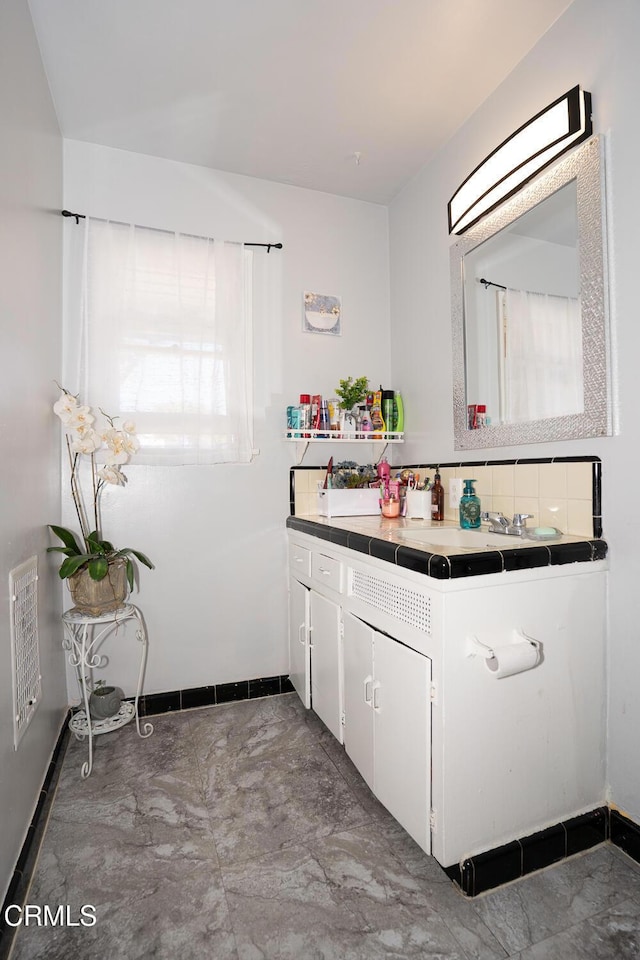153 E Date St, Oxnard, CA 93033 - bathroom with vanity and baseboards
