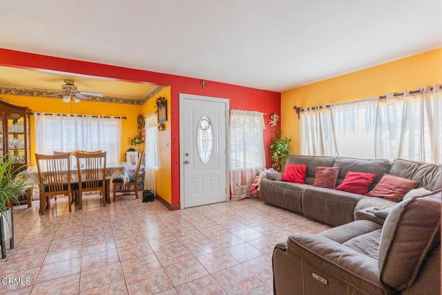 153 E Date St, Oxnard, CA 93033 - living area with healthy amount of natural light, a ceiling fan, and light tile patterned floors