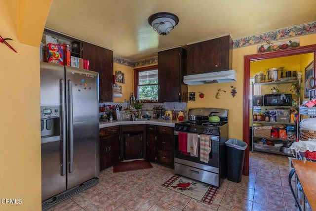 153 E Date St, Oxnard, CA 93033 - kitchen featuring stainless steel appliances, under cabinet range hood, tile countertops, dark brown cabinetry, and tile patterned floors