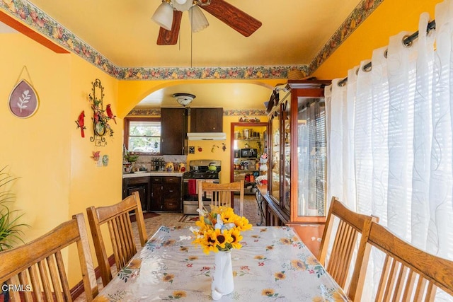 153 E Date St, Oxnard, CA 93033 - dining space featuring arched walkways and a ceiling fan