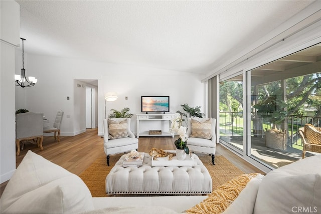 13400 Del Monte Unit 1M, Seal Beach, CA 90740 - living room with a chandelier, healthy amount of natural light, wood finished floors, vaulted ceiling, and a textured ceiling