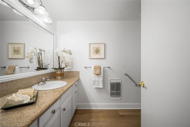 13400 Del Monte Unit 1M, Seal Beach, CA 90740 - bathroom featuring heating unit, baseboards, vanity, and wood finished floors