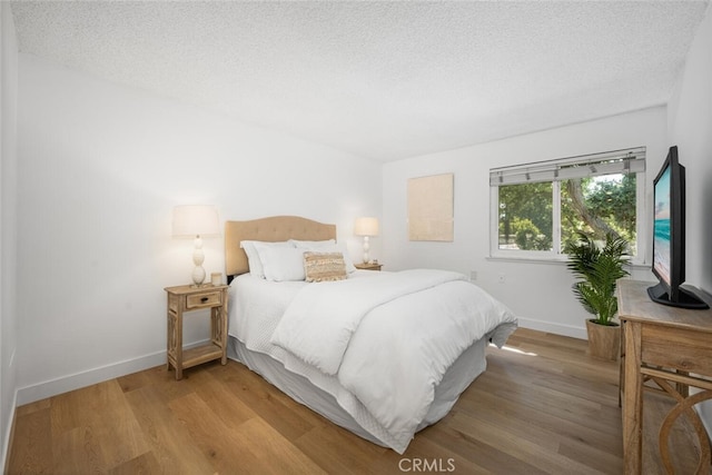 13400 Del Monte Unit 1M, Seal Beach, CA 90740 - bedroom with wood finished floors, baseboards, and a textured ceiling