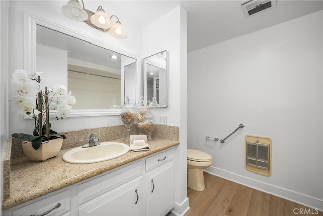 13400 Del Monte Unit 1M, Seal Beach, CA 90740 - bathroom featuring heating unit, toilet, vanity, wood finished floors, and baseboards