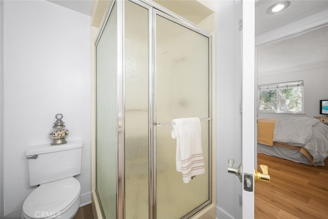 13400 Del Monte Unit 1M, Seal Beach, CA 90740 - ensuite bathroom featuring wood finished floors, a shower stall, toilet, a textured ceiling, and recessed lighting