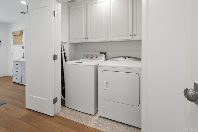 8014 La Jolla Shores Dr, La Jolla, CA 92037 - laundry room featuring cabinet space, washing machine and dryer, and light wood-style flooring