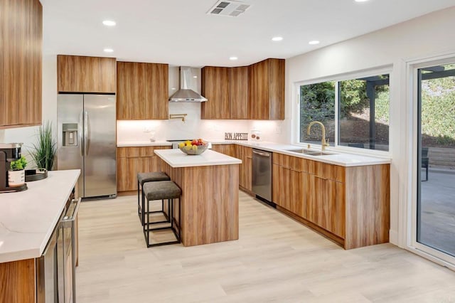 6745 Mewall Dr, San Diego, CA 92119 - kitchen featuring stainless steel appliances, wall chimney exhaust hood, modern cabinets, light wood-style floors, and recessed lighting