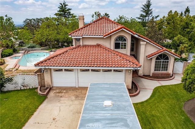 9979 Timbermist Ct, Rancho Cucamonga, CA 91737 - mediterranean / spanish home with a gate, stucco siding, concrete driveway, and a chimney