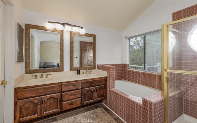 9979 Timbermist Ct, Rancho Cucamonga, CA 91737 - ensuite bathroom with lofted ceiling, a bath, double vanity, a stall shower, and wood finished floors