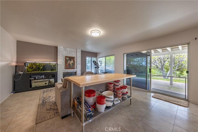 9979 Timbermist Ct, Rancho Cucamonga, CA 91737 - kitchen featuring wooden counters, a brick fireplace, light tile patterned floors, and open shelves