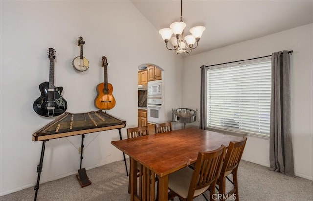 9979 Timbermist Ct, Rancho Cucamonga, CA 91737 - dining area featuring arched walkways, light colored carpet, a chandelier, vaulted ceiling, and baseboards