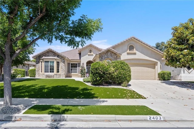 2403 Crocus Dr, Bakersfield, CA 93311 - mediterranean / spanish house featuring stone siding, stucco siding, concrete driveway, a garage, and a front lawn