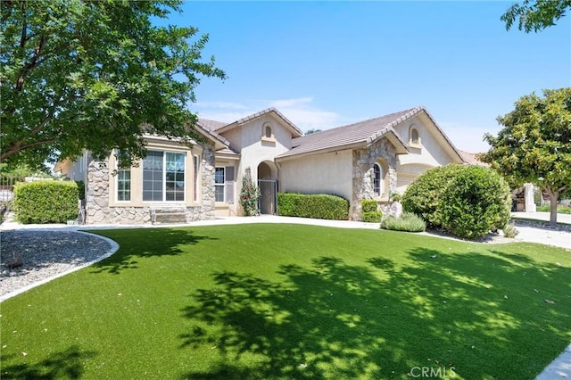 2403 Crocus Dr, Bakersfield, CA 93311 - view of front of home with stone siding, stucco siding, a front yard, and a tile roof
