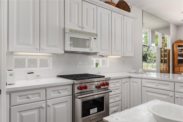 2403 Crocus Dr, Bakersfield, CA 93311 - kitchen with white microwave, premium range, white cabinets, and light countertops
