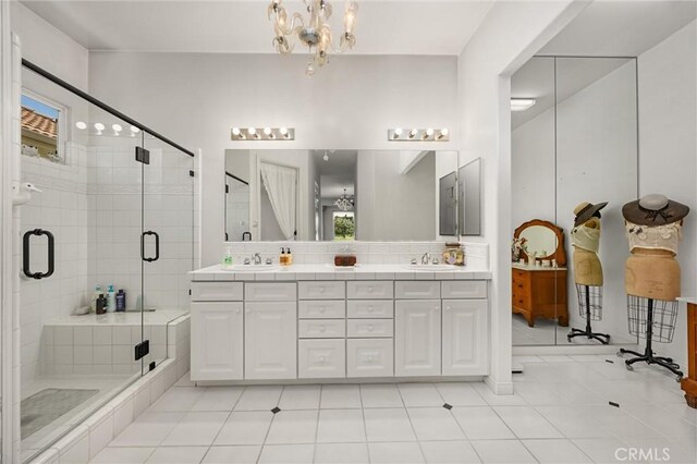2403 Crocus Dr, Bakersfield, CA 93311 - bathroom featuring double vanity, a stall shower, backsplash, and a chandelier