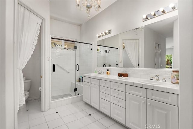 2403 Crocus Dr, Bakersfield, CA 93311 - full bath with toilet, double vanity, tile patterned flooring, a stall shower, and a chandelier